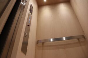 Two sophisticated residential elevator call panels with clear floor indicators and illuminated buttons