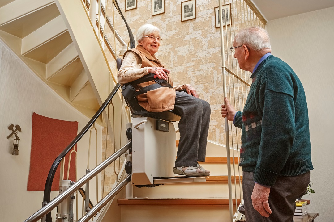 Elderly,Couple,In,The,Staircase,With,Stairlift Stairlifts for Seniors in DFW